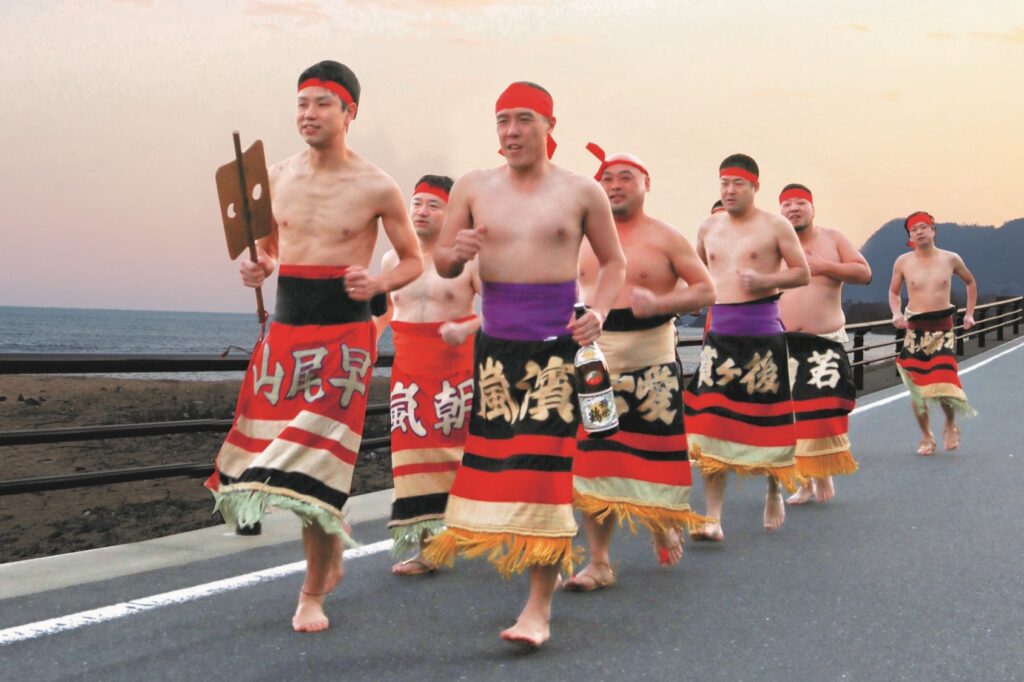 A group of men wearing ceremonial apron-style belts and running