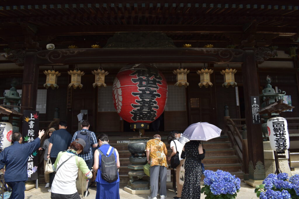 People lining up by the entrance to Yanagidani Kannon temple to go inside.